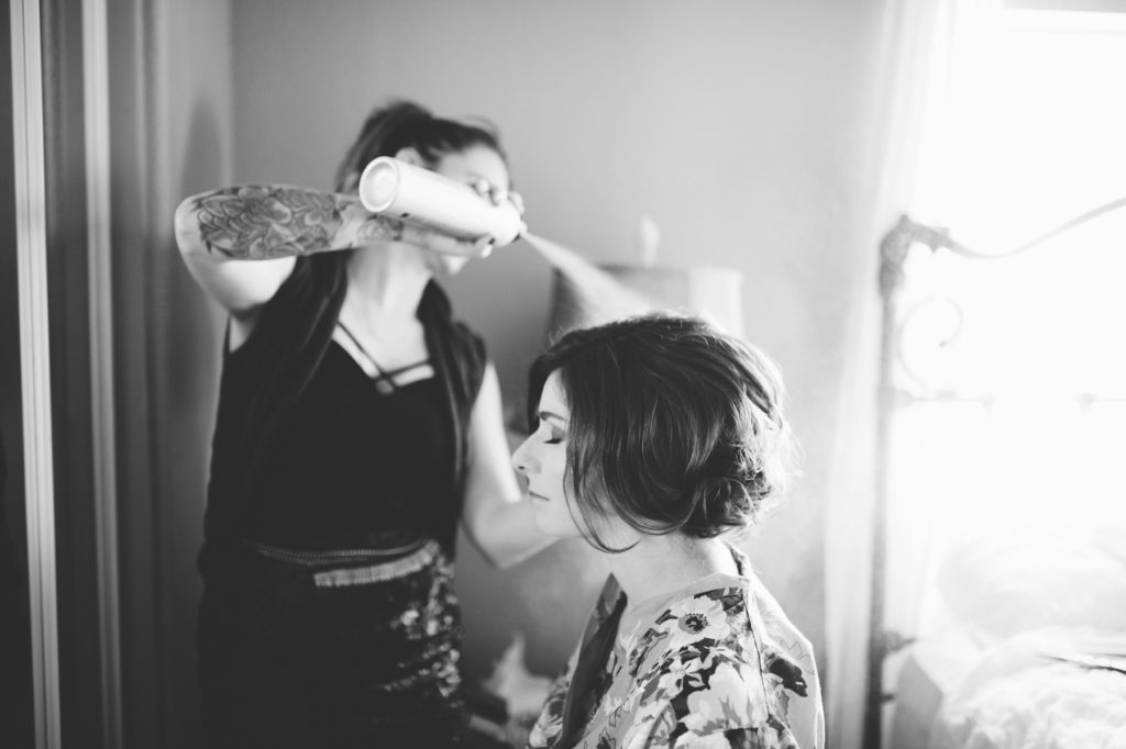 The Queens Bee finishing up bride's hair at Cass Winery in Paso Robles, California by Paso Robles Wedding Photographer Austyn Elizabeth Photography.