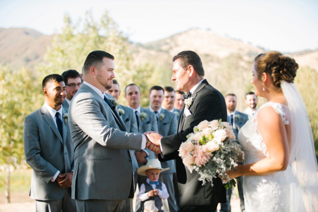 Groom and father of the bride embracing at Spanish Oaks Wedding by San Luis Obispo Wedding Photographers Austyn Elizabeth Photography