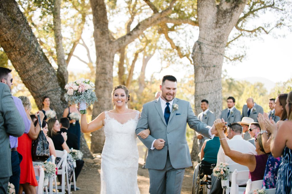 Bride and groom walking down the isle at Spanish Oaks Wedding by San Luis Obispo Wedding Photographers Austyn Elizabeth Photography
