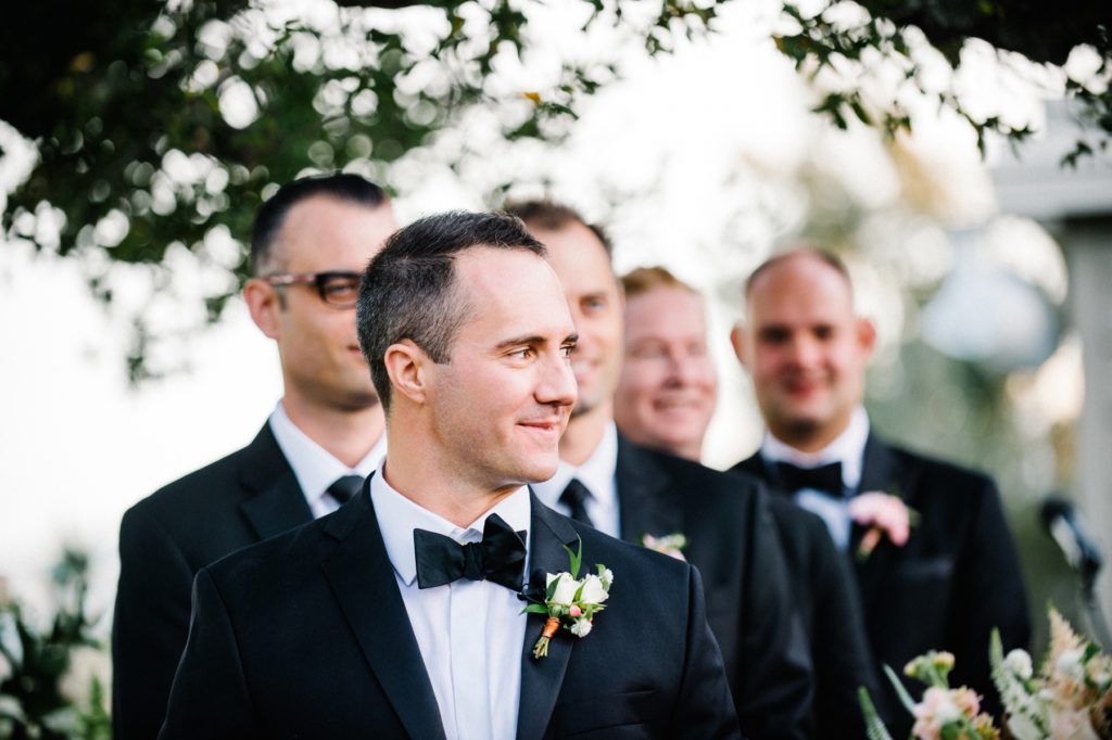 Groom smirking as bride walks down isle at Mountain Winery Wedding in Saratoga Wedding by Austyn Elizabeth Photography