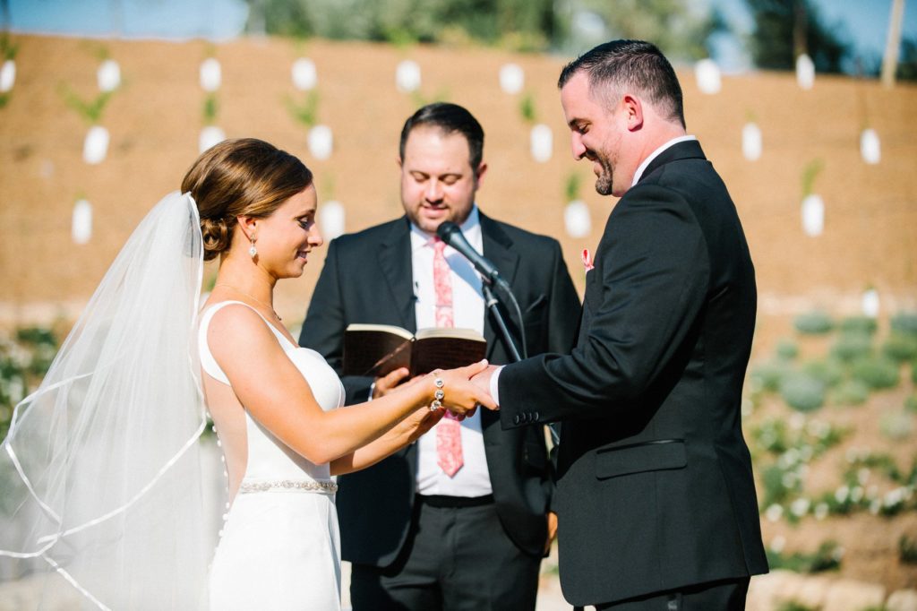 Putting on rings at Terra Mia Wedding Ceremony in Paso Robles by Austyn Elizabeth Photography
