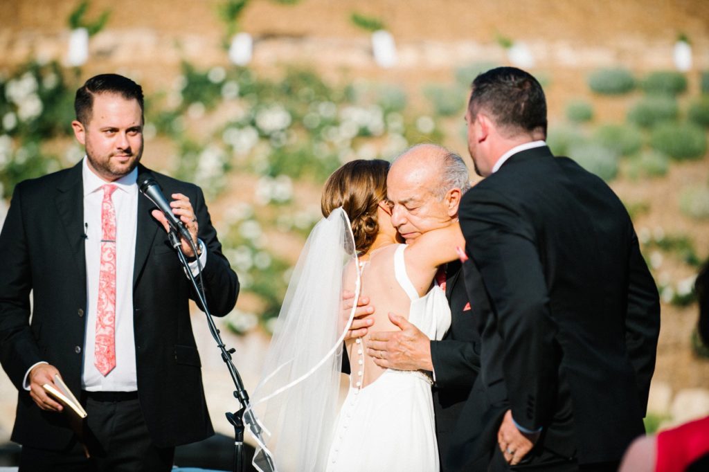 Hugs during Terra Mia Wedding Ceremony in Paso Robles by Austyn Elizabeth Photography