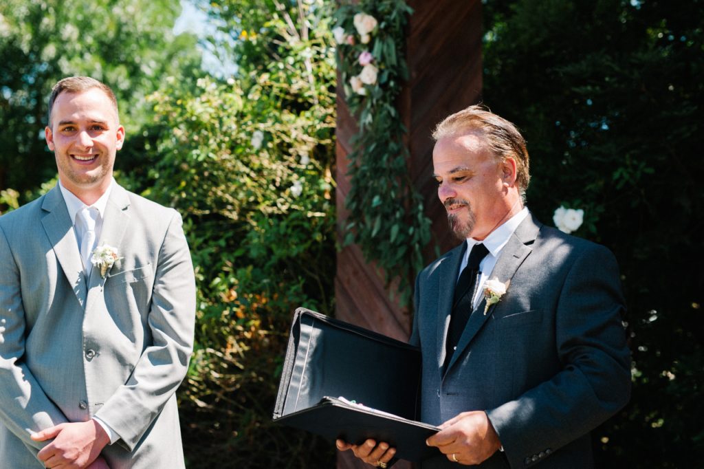 Father Marring son and bride at Grace Maralyn Estates and Garden Wedding by Austyn Elizabeth Photography