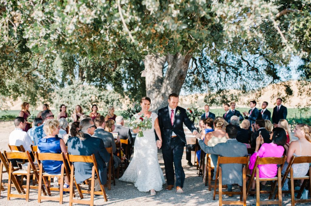 Walking down isle after i dos at cass winery wedding by paso robles wedding photographer Austyn Elizabeth Photography