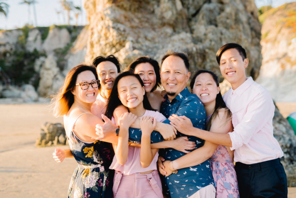 Asian family pose for family photo on Pismo beach by Austyn Elizabeth Photography