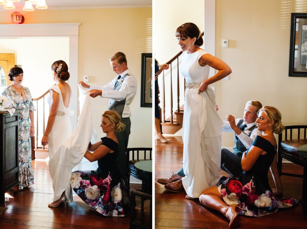 Son and daughter help bustle wedding dress at Cass House Wedding by Cayucos Wedding Photographers Austyn Elizabeth