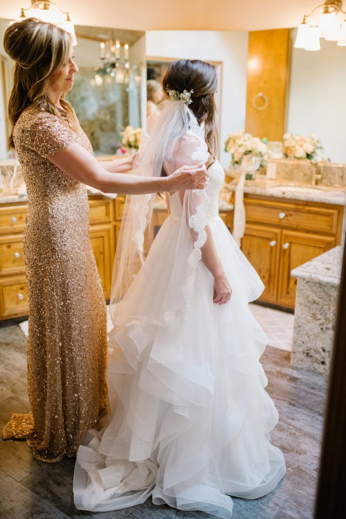 Mom getting daughter ready for wedding ceremony at at Almond Grove Wedding by Paso Robles Wedding Photographer Austyn Elizabeth Ford