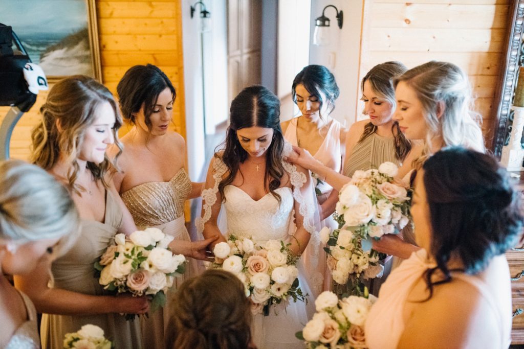 Bride with bridesmaids praying before ceremony at at Almond Grove Wedding by Paso Robles Wedding Photographer Austyn Elizabeth Ford