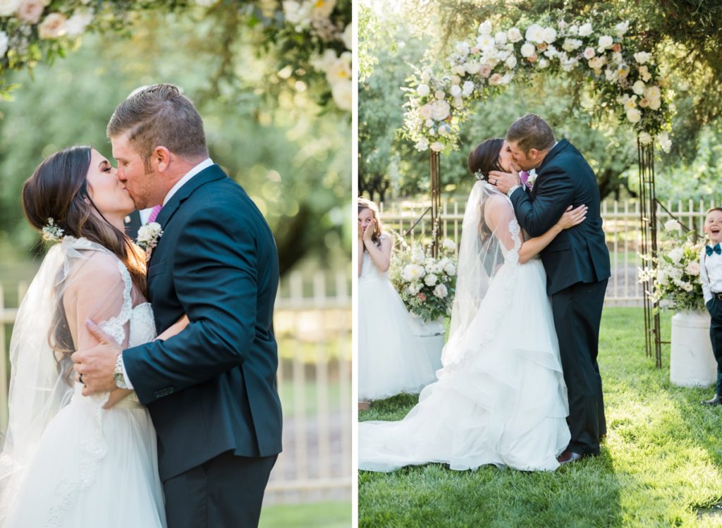 Bride and Groom's first kiss at wedding ceremony at at Almond Grove Wedding by Paso Robles Wedding Photographer Austyn Elizabeth Ford