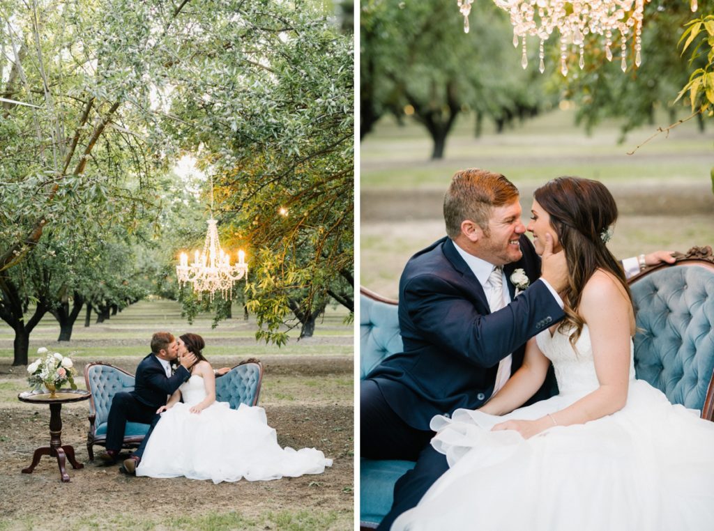 Bride and groom on vintage blue couch in almond orchard by SLO Wedding Photographers Austyn Elizabeth Photography