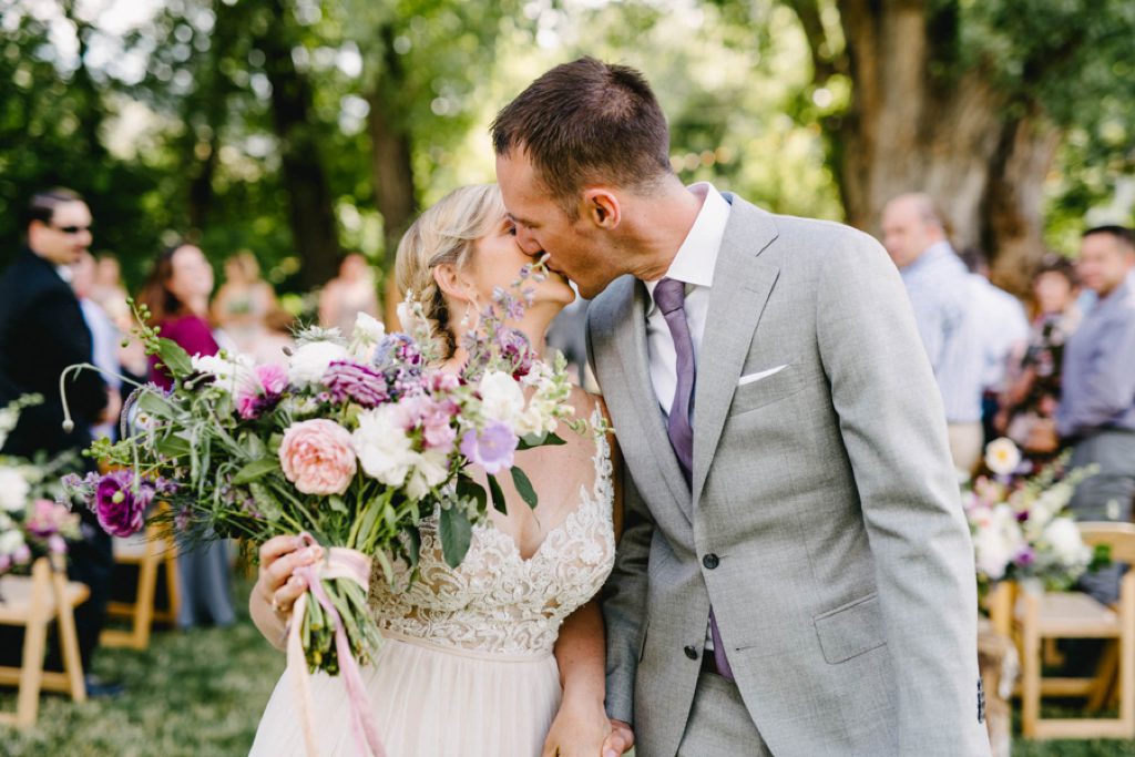 Kissing after getting married at Lyons Farmette Wedding by Austyn Elizabeth Photography