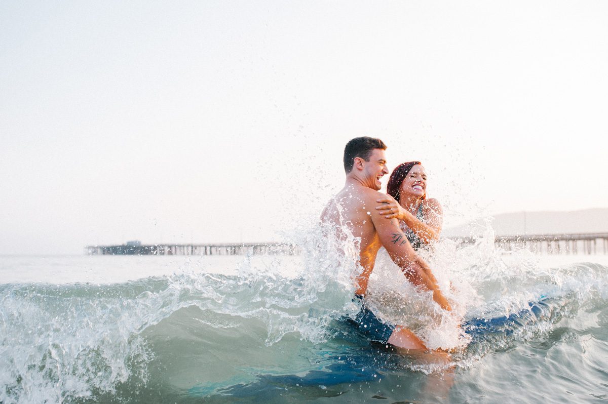 Couple surfing at Engagement Session by Avila Beach Photographer Austyn Elizabeth Photography