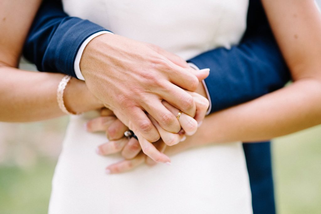 Bride and groom's hands intertwined at Estes Park Rocky Mountain Wedding by Della Terra Wedding Photographer Austyn Elizabeth Photography
