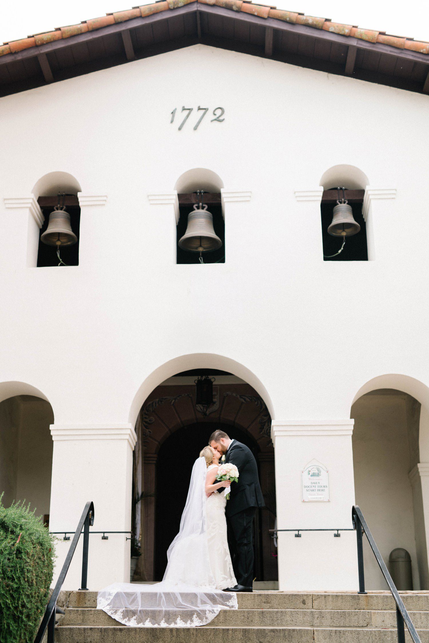 Bride and groom kissing out front of the Mission de Tolosa Wedding photographed by SLO Wedding Photographer Austyn Elizabeth Photography.