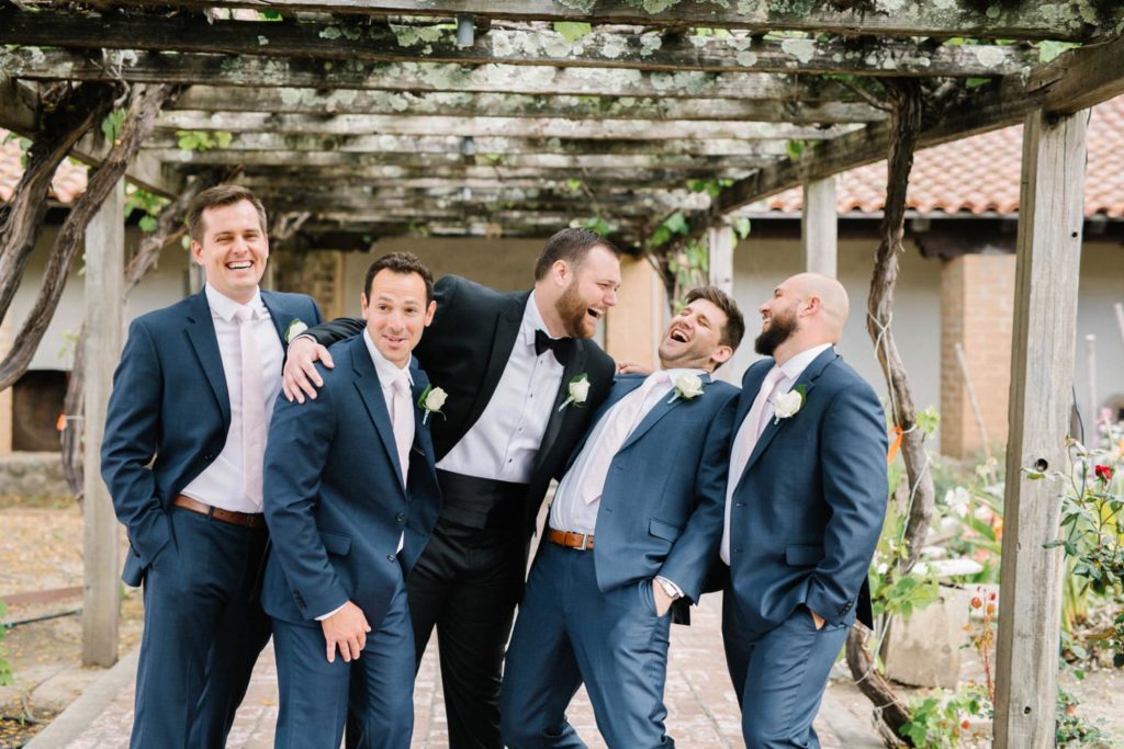 Silly Groomsmen in garden of the  Mission de Tolosa Wedding photographed by Arroyo Grande Photographer Austyn Elizabeth Photography.