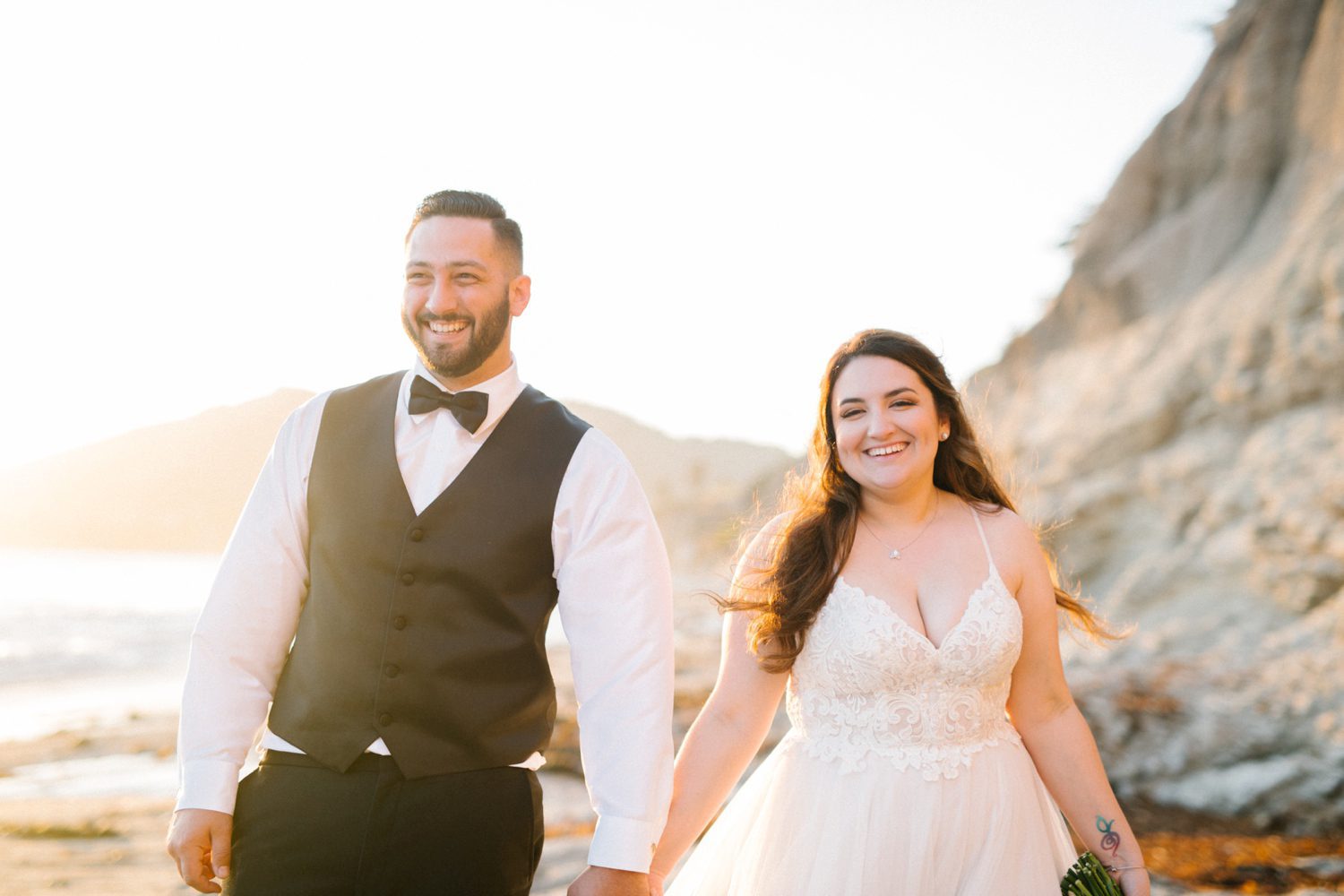Bride and groom walking holding hands smiling at Cliffs Hotel Wedding by Grover Beach Wedding Photographer Austyn Elizabeth Photography