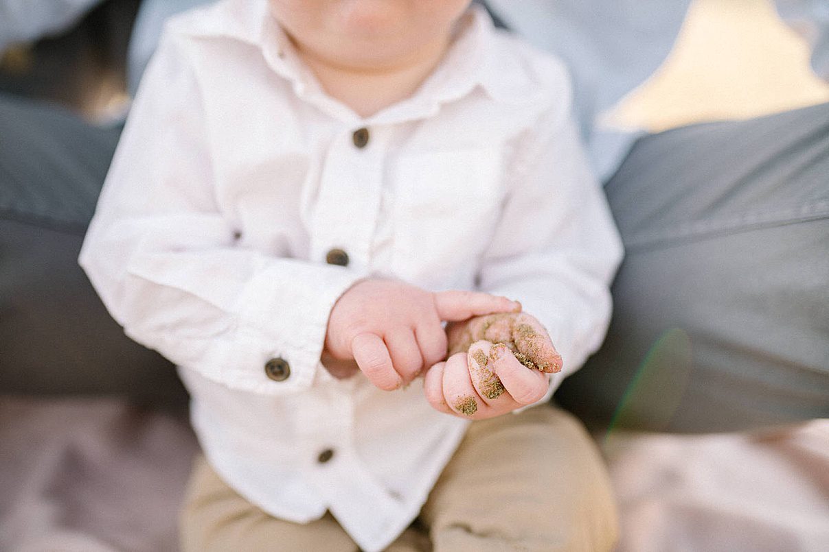 one year old hands touching sand for the first time with Pismo Beach Family Photographer Austyn Elizabeth Photography