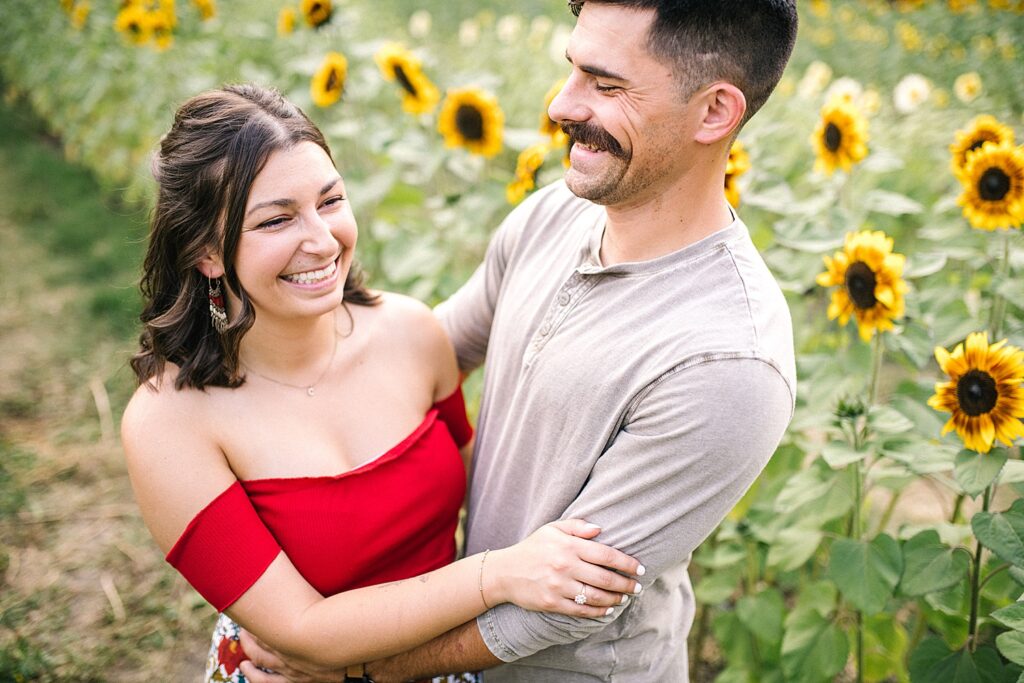 Smiling by the Sunflower field at Avila Barn Engagement Session with Avila Beach Engagement Photographer Austyn Elizabeth Photography