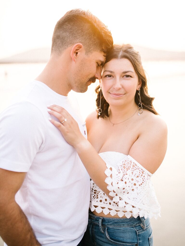 Couple snuggle together at Avila Beach engagement session by Pismo Beach engagement photographer Austyn Elizabeth Photography