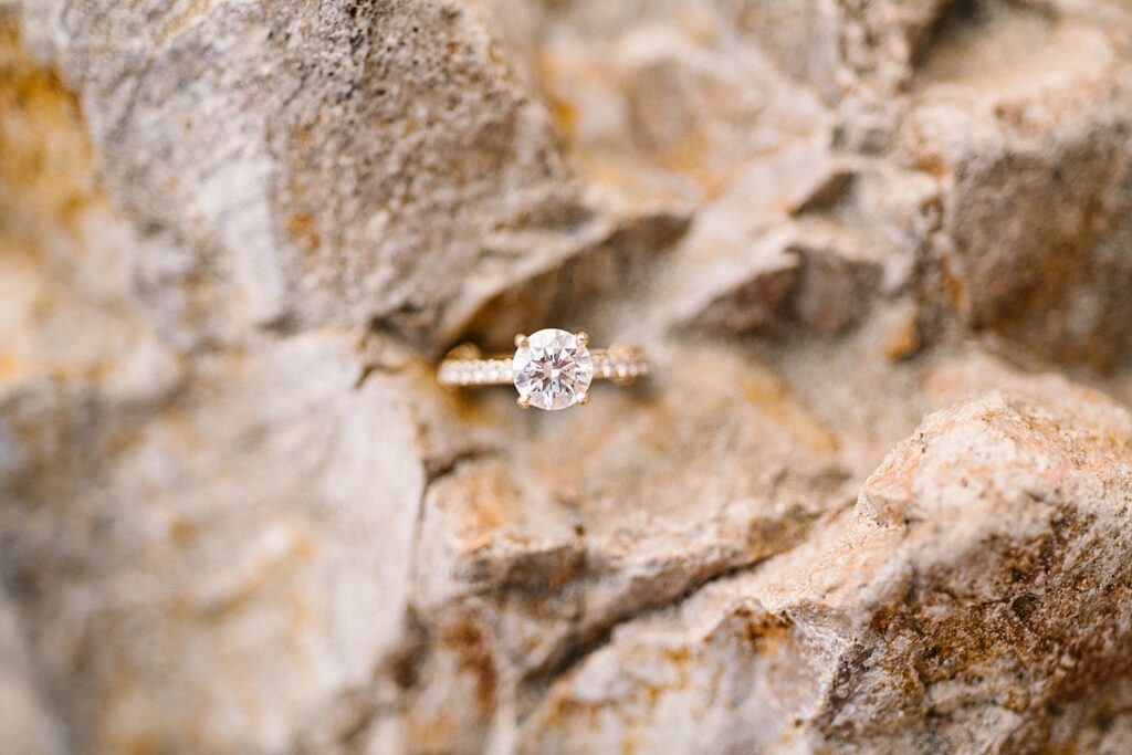 Dimond ring on golden rocks at Avila Beach engagement session by Avila Beach engagement photographer Austyn Elizabeth Photography