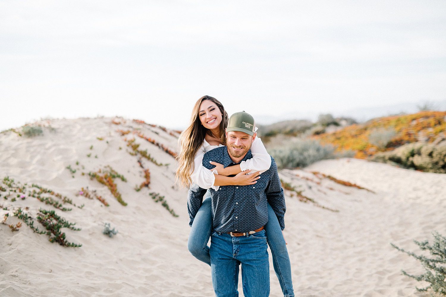 Engagement piggy back ride at Pismo Beach Dunes by Pismo Beach Engagement Photographer Austyn Elizabeth Photography