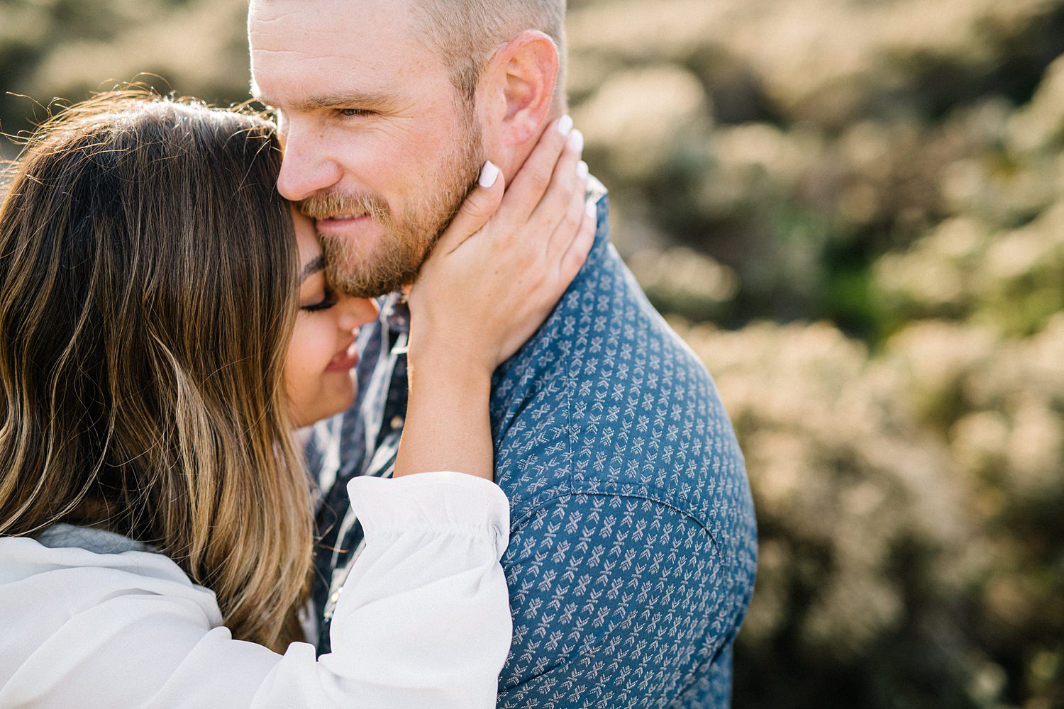 Close up embrace during engagement session on Pismo Beach Dunes by Pismo Beach Engagement Photographer Austyn Elizabeth Photography