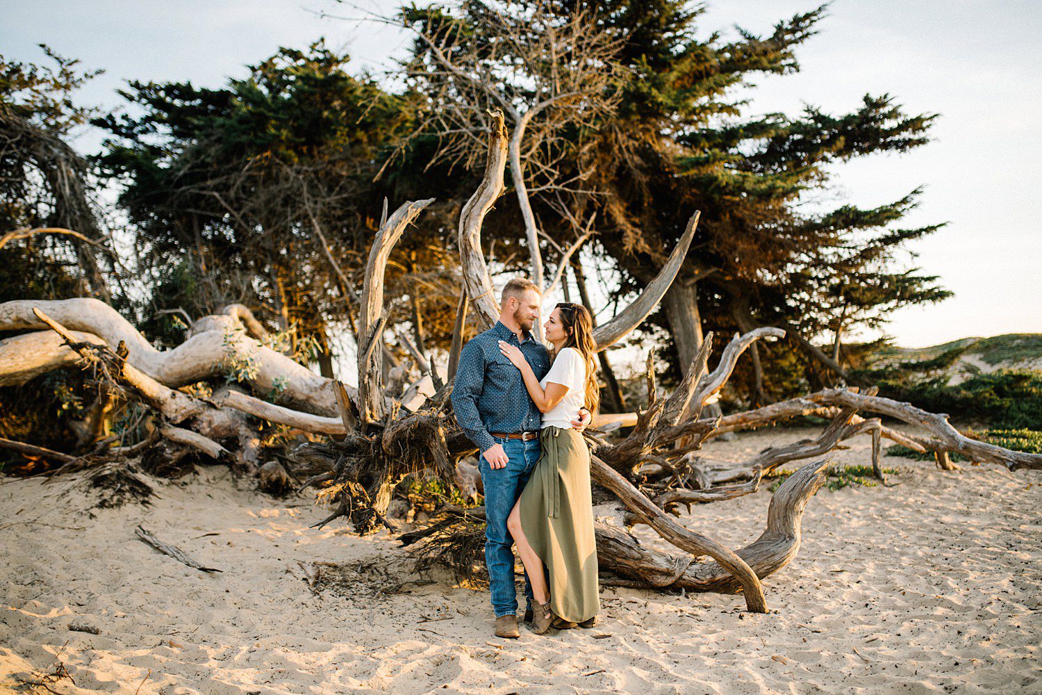 In front of fallen driftwood engagement session in Pismo Beach at Sunset by Pismo Beach Engagement Photographer Austyn Elizabeth Photography