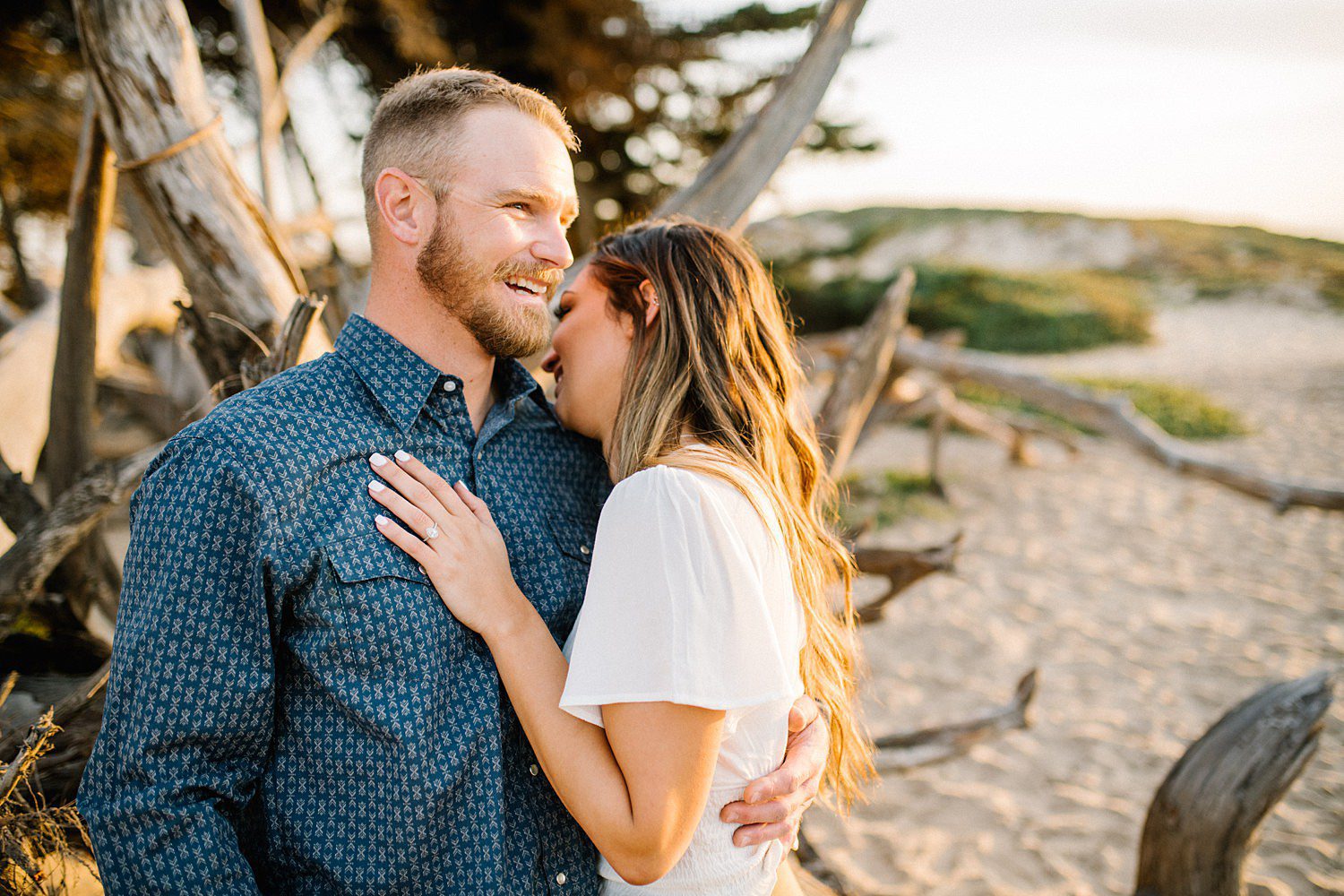 Couple laughs during engagement photos at Pismo Beach Dunes at Sunset by Pismo Beach Wedding Photographer Austyn Elizabeth Photography