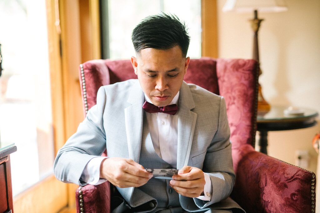 Groom reading his gift from his bride at The Casitas Estate Wedding by Arroyo Grande Wedding Photographer Austyn Elizabeth Photography
