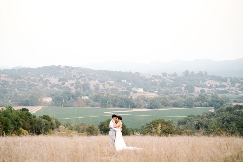 Bride and groom embrace during hazy smoke filled sky at The Casitas Estate Wedding by Arroyo Grande Wedding Photographer Austyn Elizabeth Photography