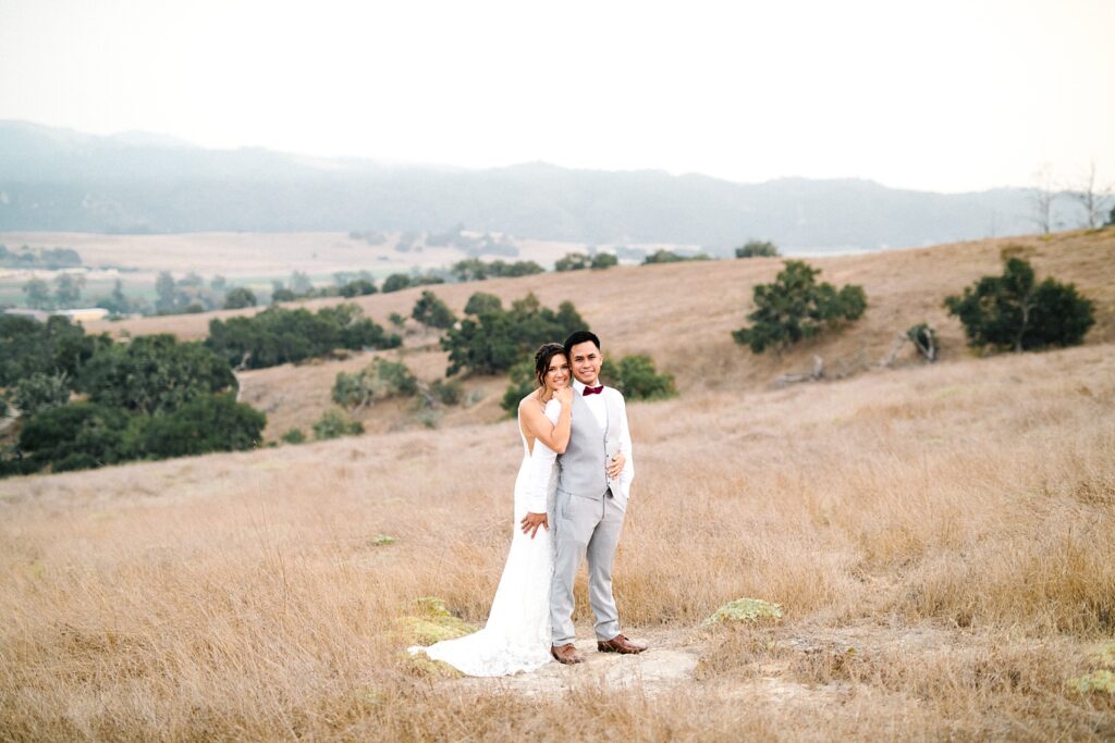 Bride and groom stand on rock at The Casitas Estate Wedding by Arroyo Grande Wedding Photographer Austyn Elizabeth Photography