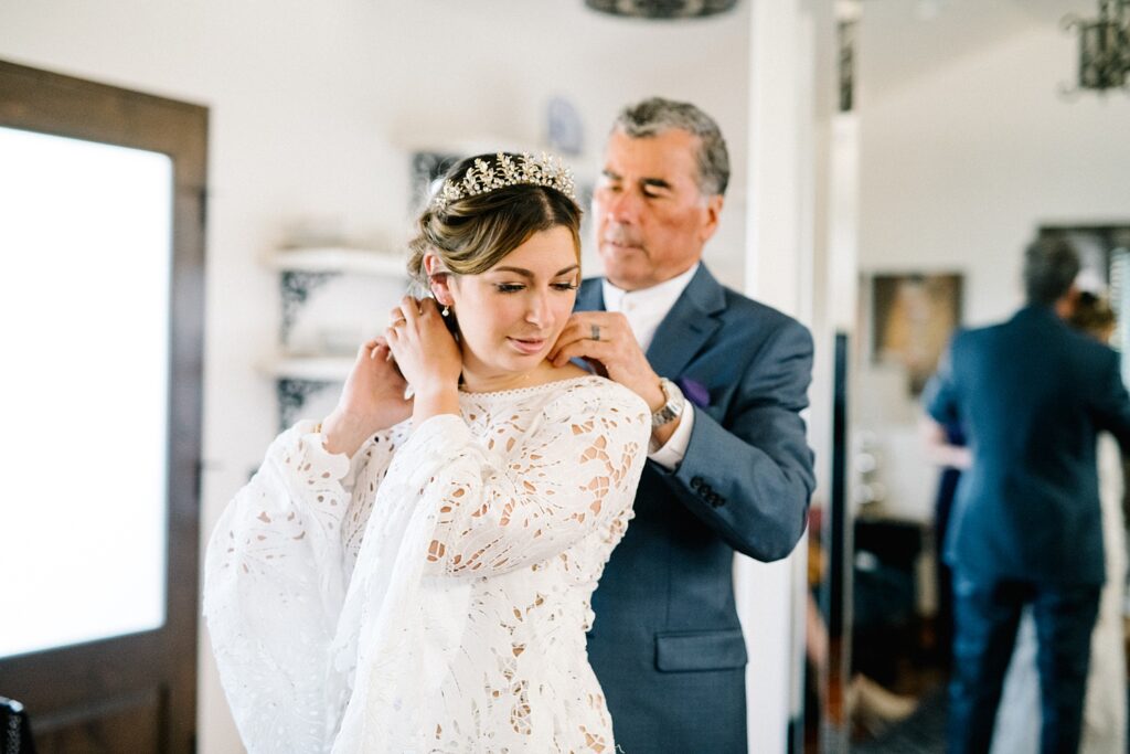 father helping put on necklace on bride at La Lomita Ranch Wedding by Pismo Beach Wedding Photographer Austyn Elizabeth Photography