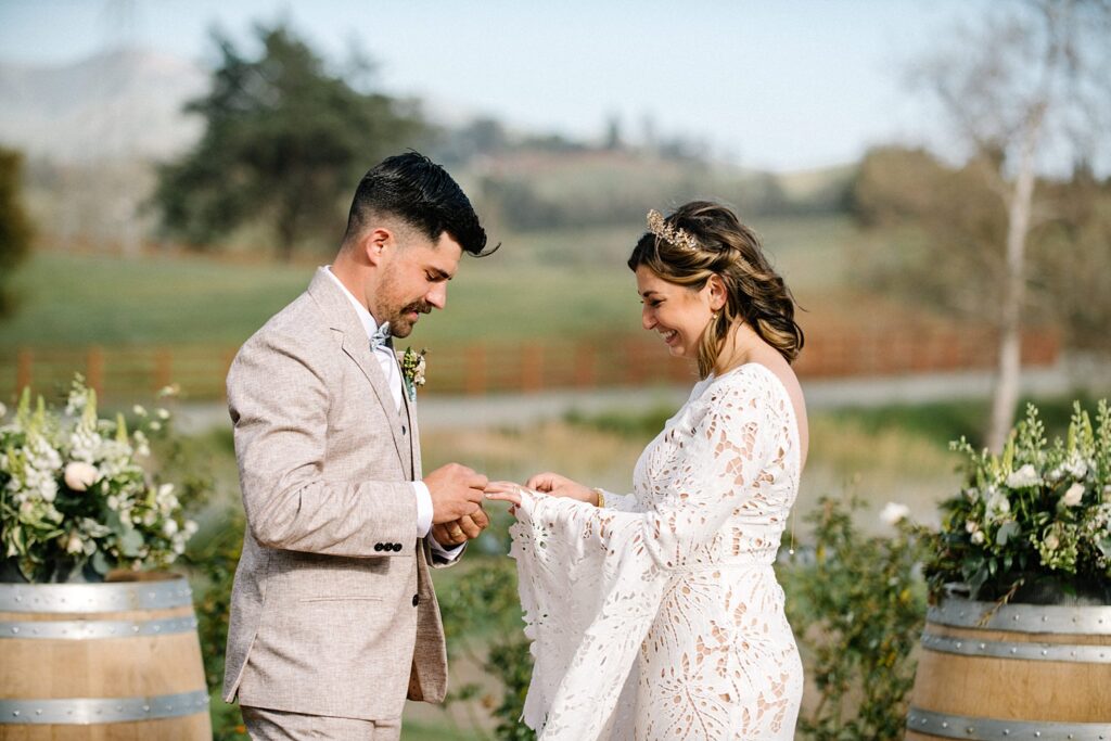 groom placing ring on bride's finger at La Lomita Ranch Wedding by SLO Wedding Photographer Austyn Elizabeth Photography