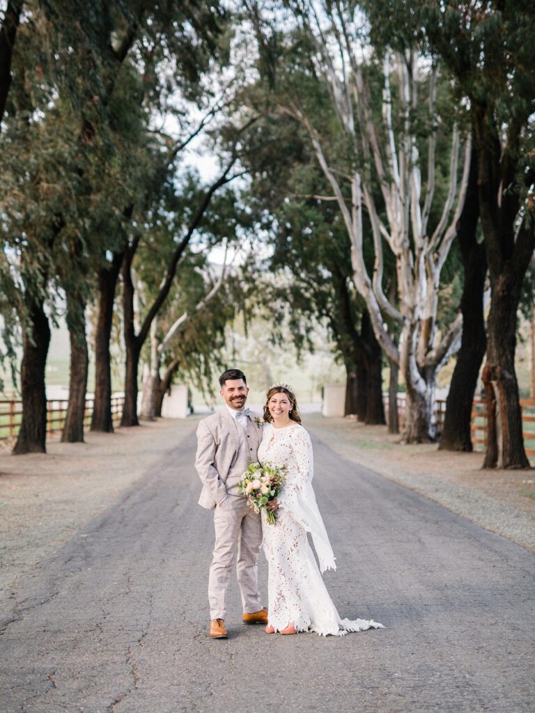 Bride and groom on road with eucalyptus trees at La Lomita Ranch Wedding by San Luis Obispo Wedding Photographer Austyn Elizabeth Photography