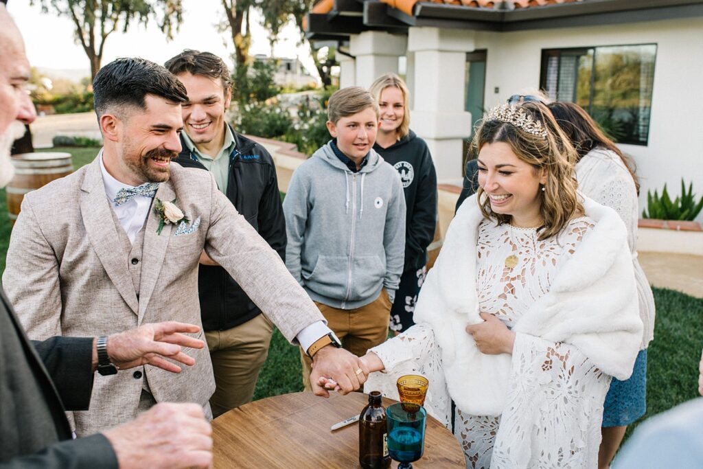 Bride and groom surprised by magic card trick at La Lomita Ranch Wedding by Arroyo Grande Wedding Photographer Austyn Elizabeth Photography