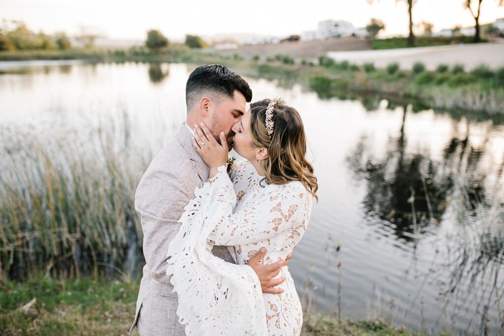 Bride and groom kiss by pond at La Lomita Ranch Wedding by SLO Wedding Photographer Austyn Elizabeth Photography