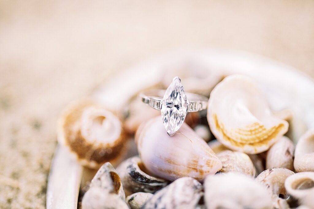 Marquise Cut Diamond engagement ring passed down from great aunt to bride standing in seashells by Catalina Wedding Photographer Austyn Elizabeth Photography