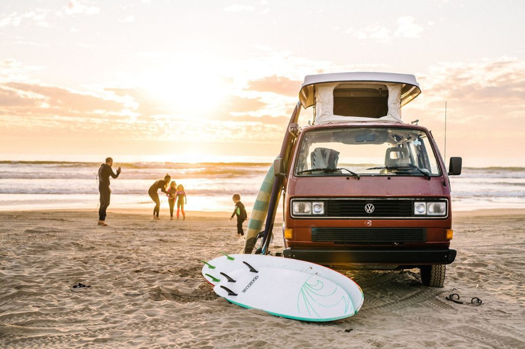 family with young kids in wetsuits at Pismo beach with surfboards and a VW Westy at sunset by Pismo beach Family photographer Austyn Elizabeth Photography