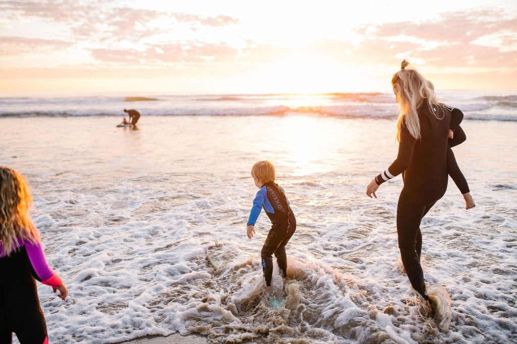 Surfing family at Pismo Beach during sunset by Pismo Beach Family photographer Austyn Elizabeth Photography
