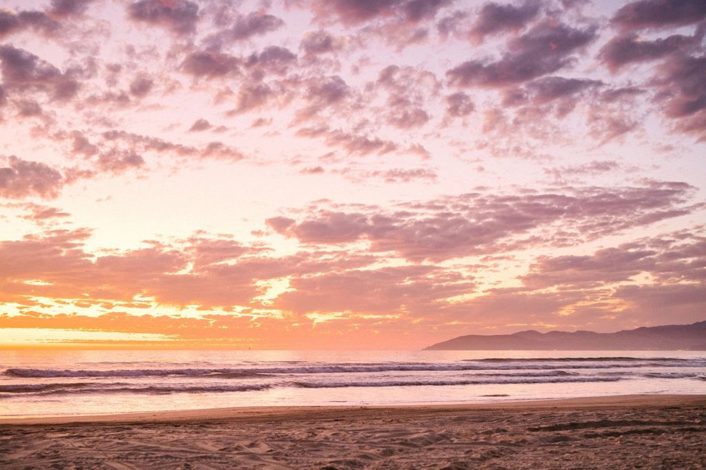 Sunset during surfboard family session by california coast wedding photographer Austyn Elizabeth Photography