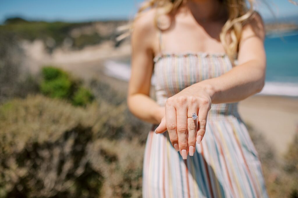 Showing off the engagement ring at surprise proposal at Montana De Oro's Spooners Cove by Pismo beach engagement photographer austyn elizabeth photography
