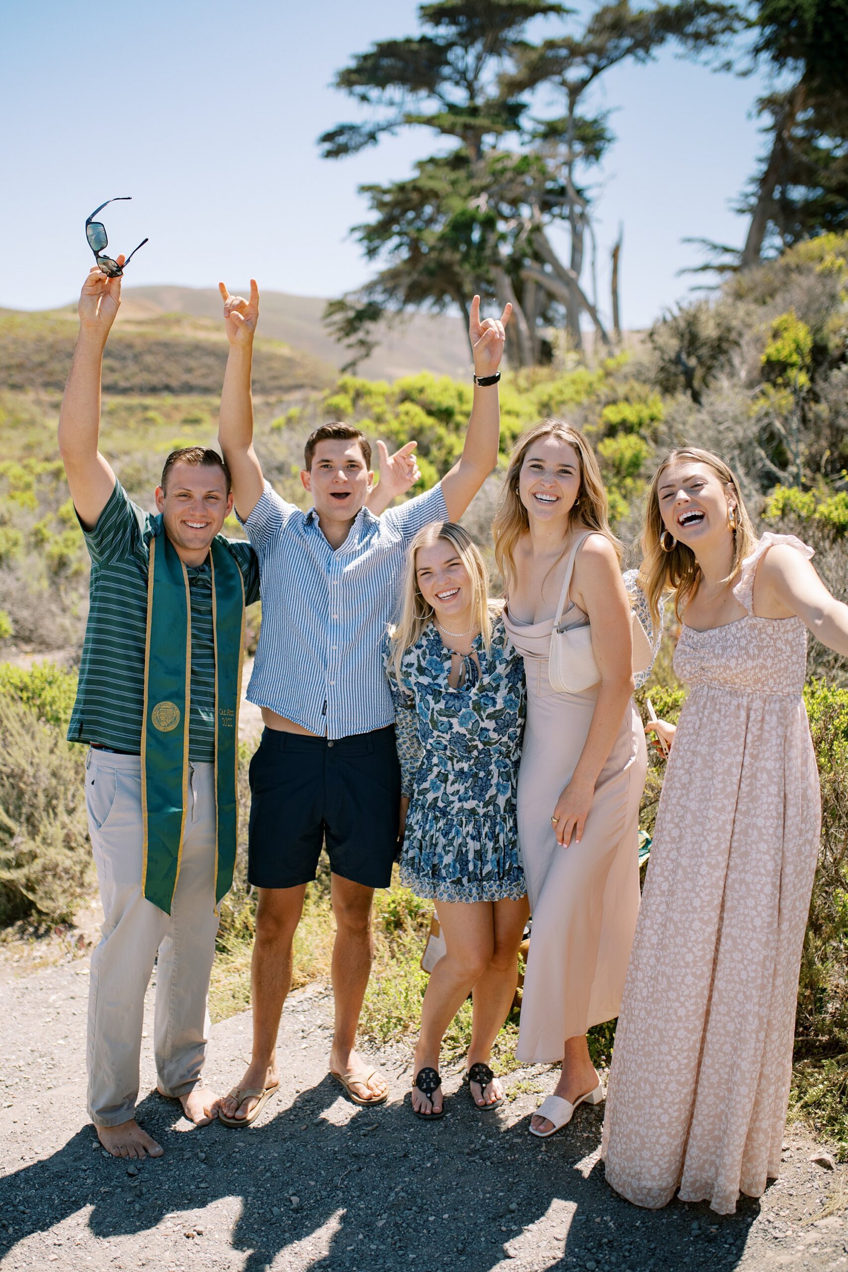 friends cheers at surprise proposal at Montana De Oro's Spooners Cove by Pismo beach engagement photographer austyn elizabeth photography