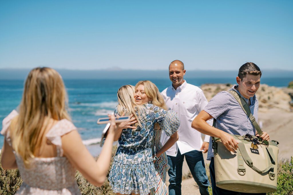 friends together at surprise proposal at Montana De Oro's Spooners Cove by Pismo beach engagement photographer austyn elizabeth photography