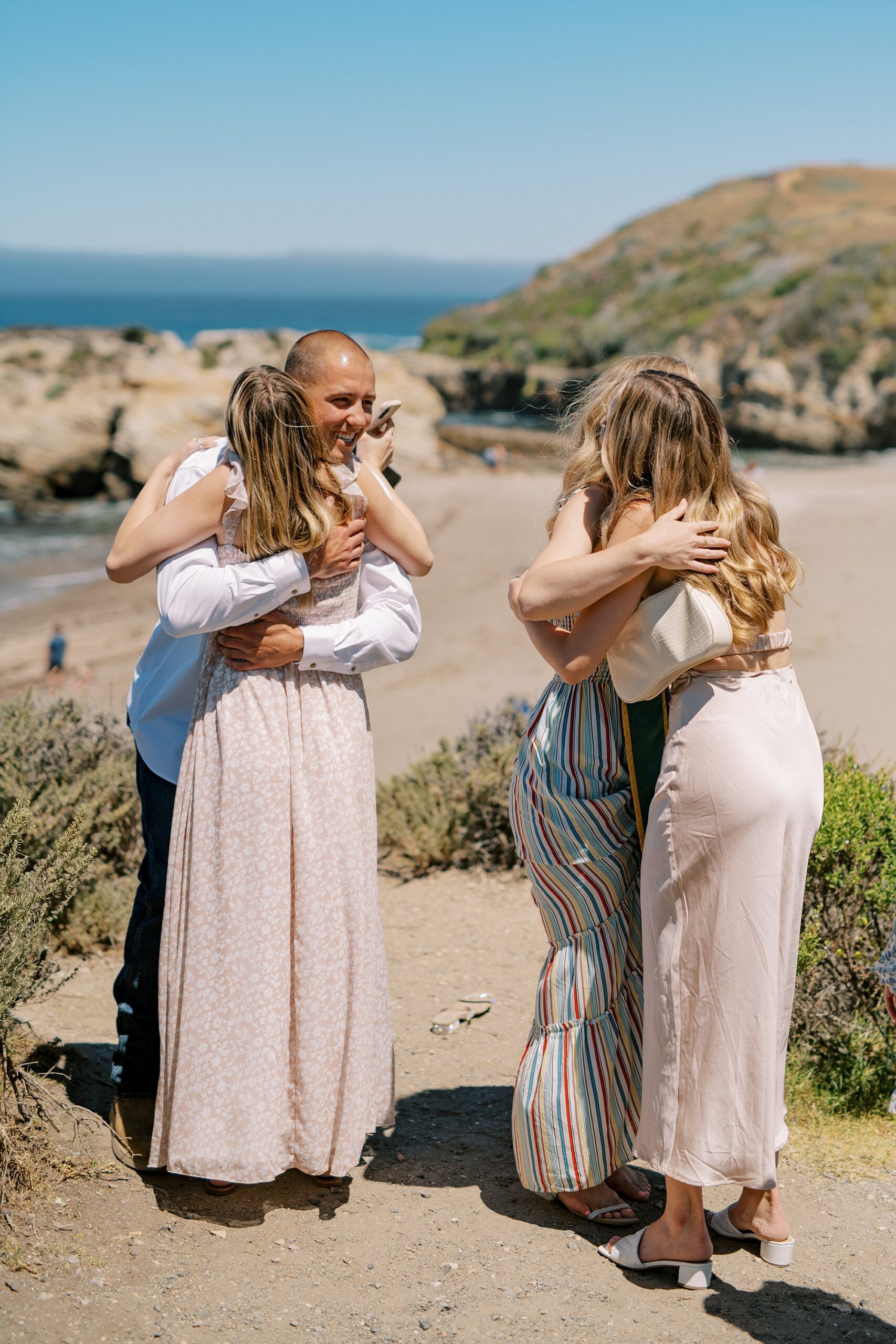 Congratulations and hugs at surprise proposal at Montana De Oro's Spooners Cove by Pismo beach engagement photographer austyn elizabeth photography