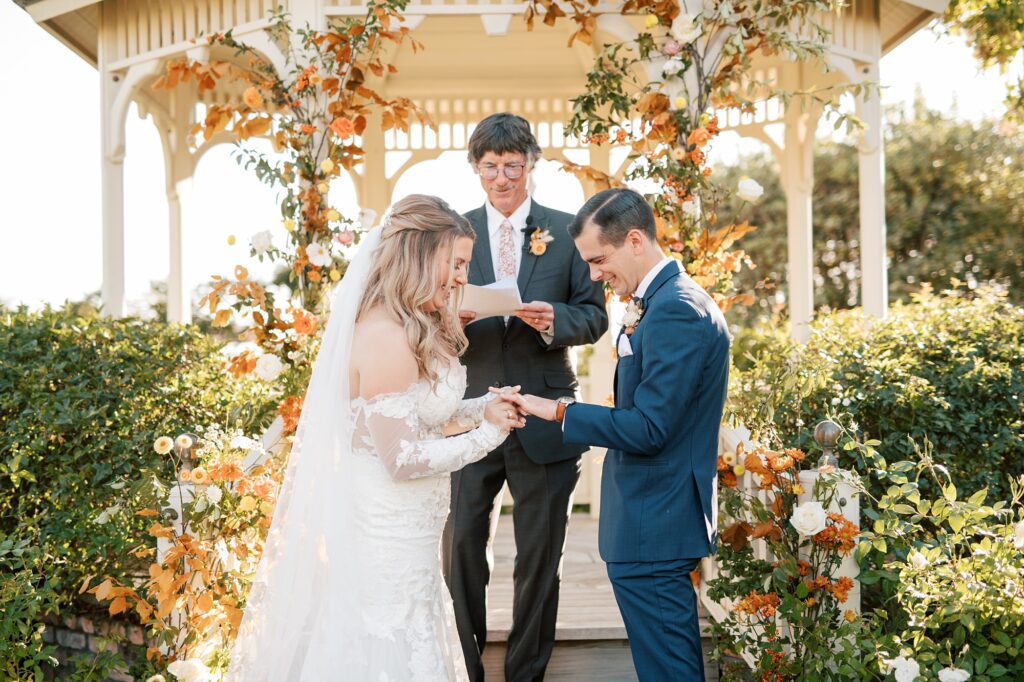 Placing the ring on the groom's finger at California autumn coastal wedding at Cass House Cayucos Wedding by Pismo Beach Wedding Photographer Austyn Elizabeth Photography