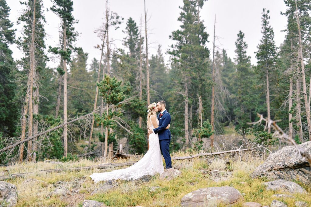 Couple kissing at Sprague Lake at Destination Rocky Mountain National Forest Wedding by Estes park Wedding Photographer Austyn Elizabeth Photography