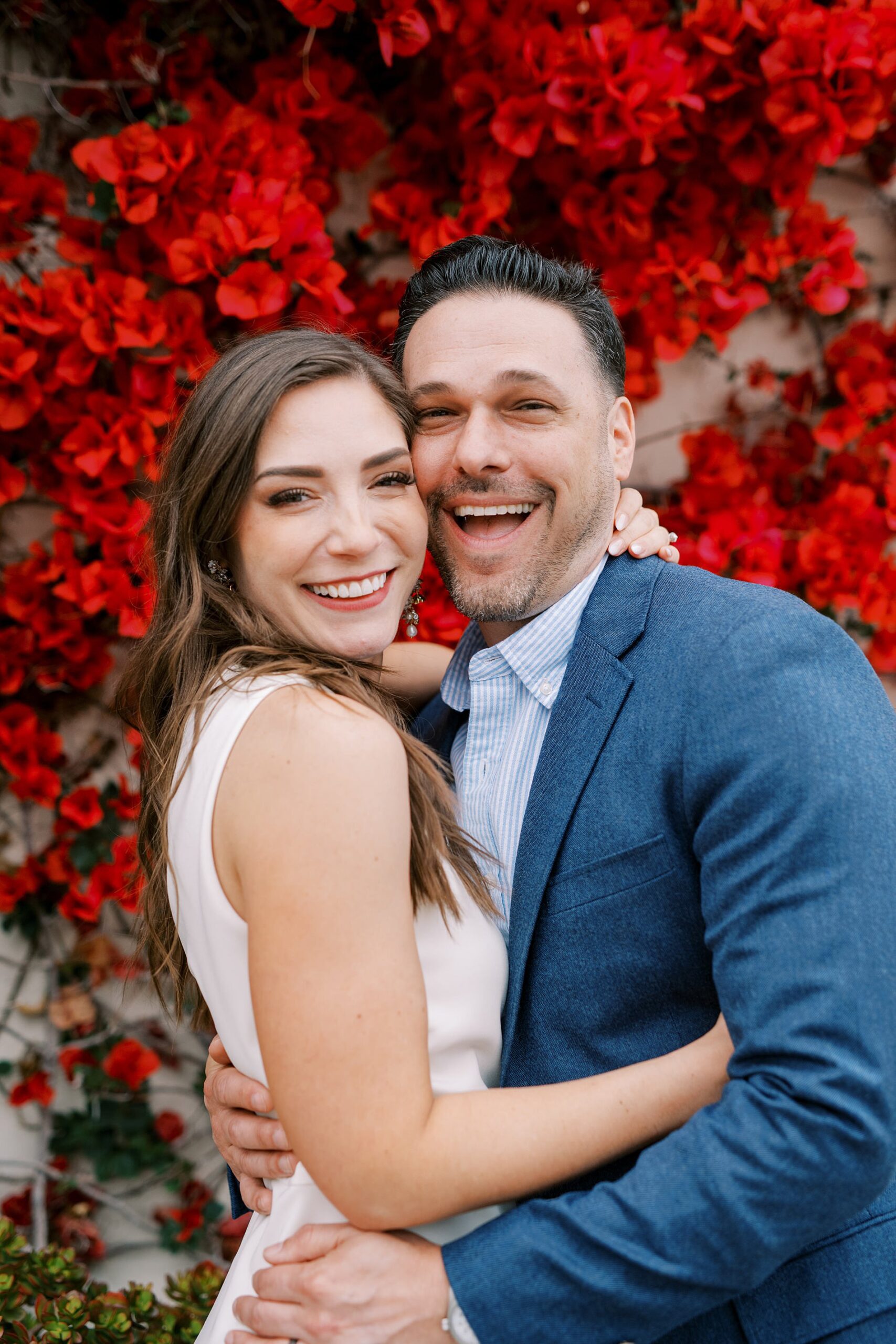 Bride and Groom in front of deep red bougainvillea well after their catalina island elopement in may by Catalina island elopement photographer Austyn Elizabeth Photography
