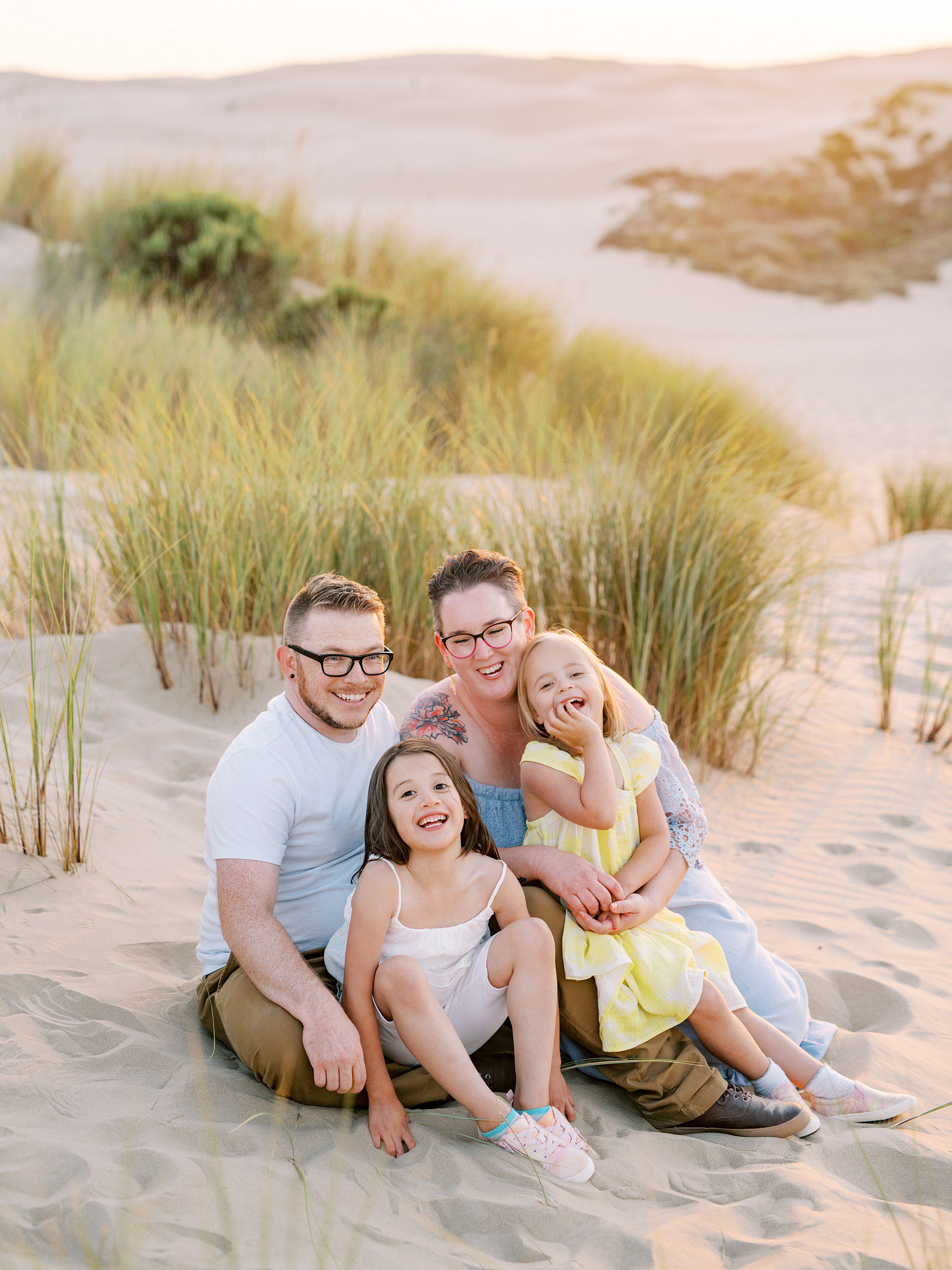 Playful family sit at the Oceano Dunes during family session by Pismo beach family photographer Austyn Elizabeth Photography