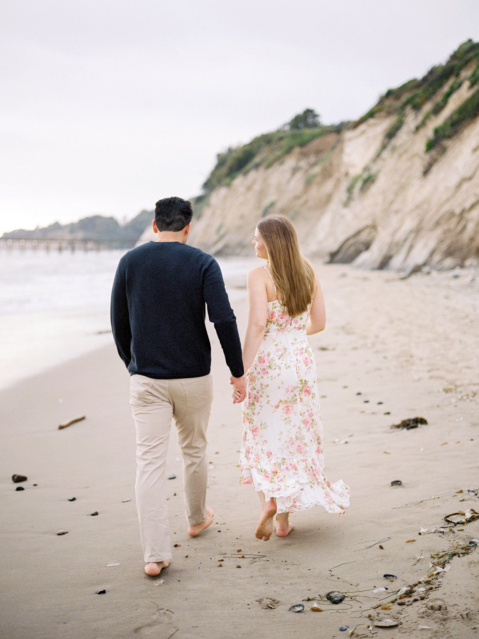 Couple walks along the beach hand in hand at the Ritz Carlton Bacara photographed by Santa Barbara wedding photographer Austyn Elizabeth Photography