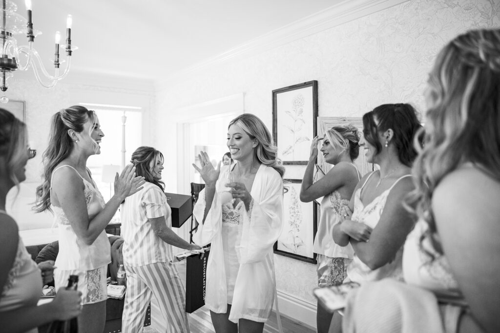 Bride getting ready surrounded by her bridesmaids inside the estate house in black and white at Lamoure Vienyard by San Luis Obispo Wedding Photographer Austyn Elizabeth Photography